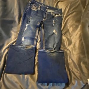 Distressed bootcut blue jeans